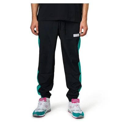 New Balance MP91507 VDE NB Athletics Windbreaker Pant (Schwarz / Türkis)