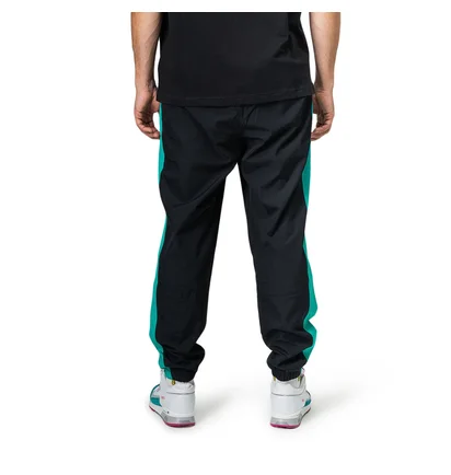 New Balance MP91507 VDE NB Athletics Windbreaker Pant (Schwarz / Türkis)