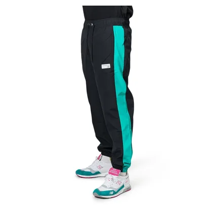 New Balance MP91507 VDE NB Athletics Windbreaker Pant (Schwarz / Türkis)